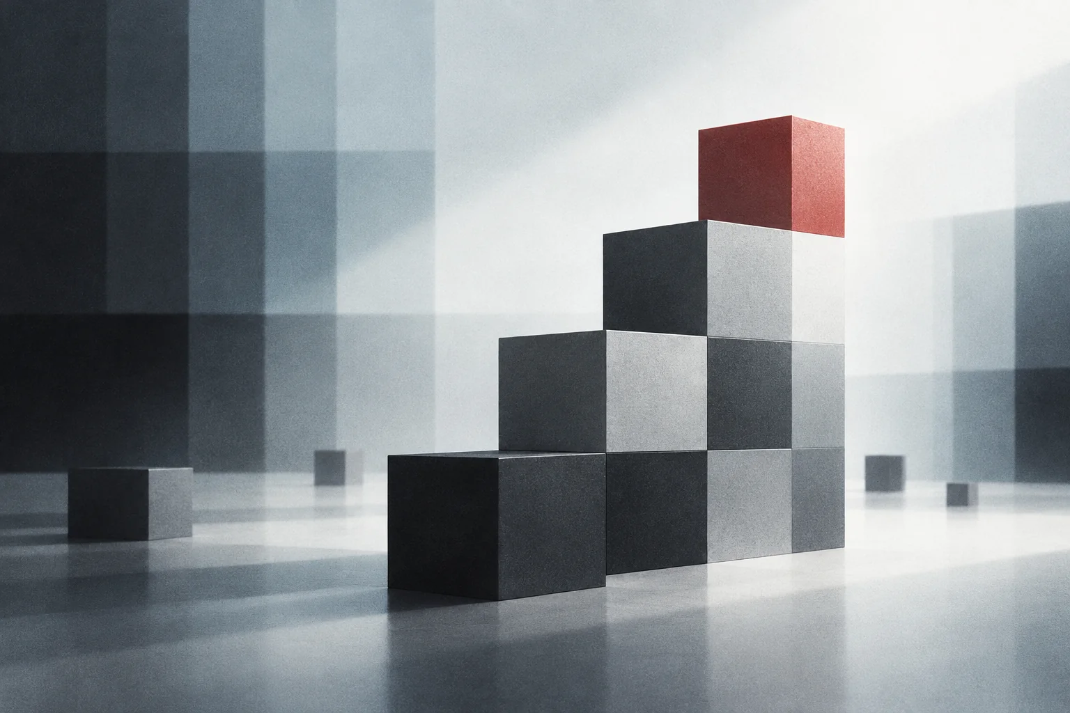 A staircase of gray pixel blocks with one red cube at the top